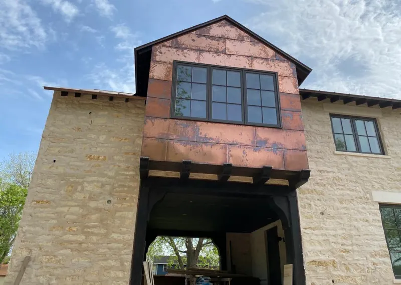 Copper metal panel facade on a stone building for Skylight Installation in Vero Beach South